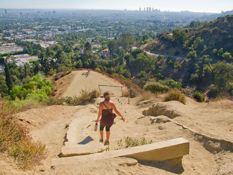Hiker at Runyon Canyon Park, with a view of downtown Los Angeles