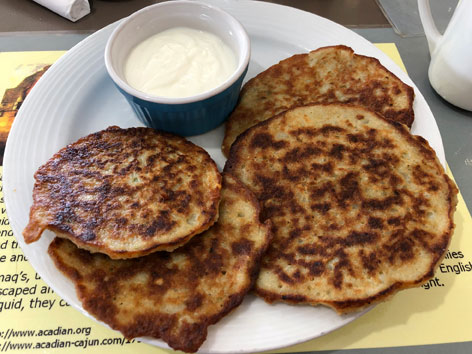 Acadian potato pancakes with sour cream in Nova Scotia.