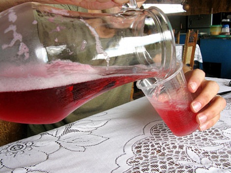 Pouring refajo from a glass pitcher in San Gil, Colombia.