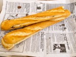 Two breakfast baguettes on newspaper in Dakar, Senegal.