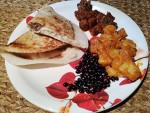 A plate of chatamari, Nepali crepe, with some sides of beans, potatoes, and meat from Kathmandu.