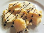 Hunks of Parmigiano-Reggiano cheese with a drizzle of balsamic vinegar from Trattoria Vigolante in Parma, Italy. 